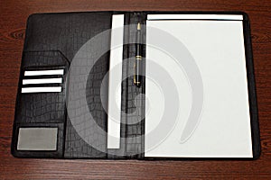 Business leather folder with pen and white blank note paper