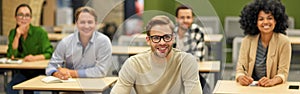 Business lecture. Group of happy multiracial people sitting in the modern office and listening to coach or speaker