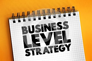 Business Level Strategy - examine how firms compete in a given industry, text concept on notepad