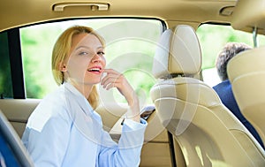 Business life concept. Business woman sit on backseat. Busy lady passenger leather car salon enjoy journey with