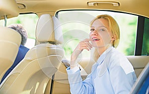 Business life concept. Business woman sit on backseat. Busy lady passenger leather car salon enjoy journey with