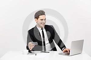 Business and Lifestyle Concept: Portrait smiling businessman sitting in office and shopping online pays by credit card