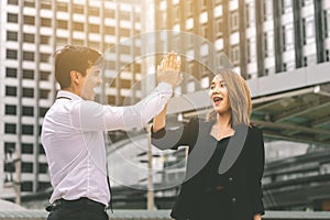 Business lover couple hi five for success in modern city