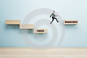Business man with abstract crisis management gap on wall background. Business obstacle and recovery concept