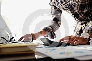 Business man or accountant working with laptop computer for calculating financial accounting at office