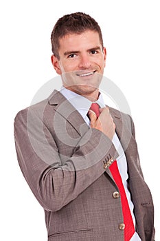 Business man adjusting his tie