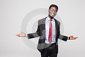 Business man african american doing a balance on grey background
