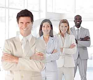 Business man with arms folded with Business Team