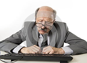 Business man with bald head on his 60s working stressed and frustrated at office computer laptop desk looking tired