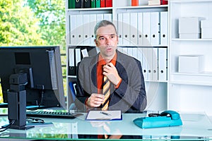 Business man behind his desk in summerly hot office