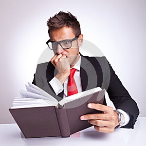 Business man being affraid by the book
