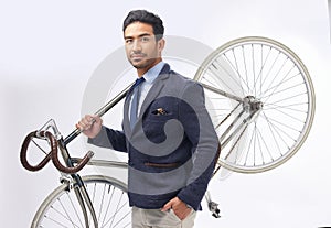 Business man, bicycle and studio portrait with retro suit, sustainable transport or pride by white background. Young