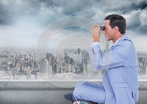Business man with bionoculars against grey skyline and clouds