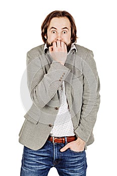 business man biting his nails fingers freaking out. human emotion expression and lifestyle concept. image on a white studio