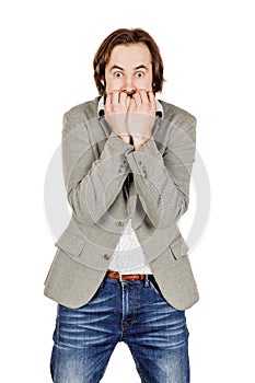 business man biting his nails fingers freaking out. human emotion expression and lifestyle concept. image on a white studio