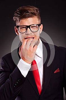 Business man bitting nails