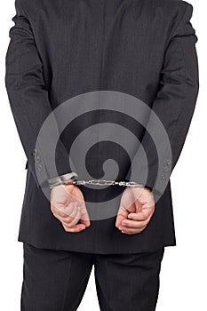 Business man with a black suit in handcuffs