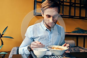 business man in blue shirt having lunch at a cafe table