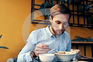 business man in blue shirt having lunch at a cafe table