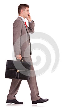 Business man with briefcase on the phone