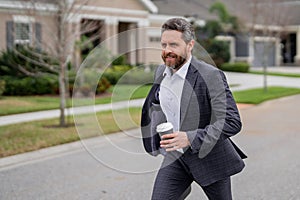 Business man with briefcase and take away coffee run outdoor. Businessman run down street, late meeting. Running