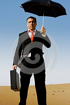 A business man with a briefcase and a umbrella