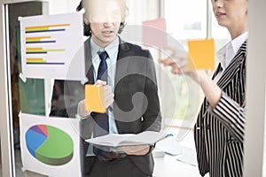 Business man and business woman are analytics business data, business plan concept