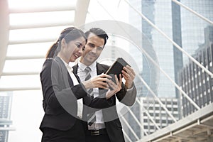 Business man and business woman partner using tablet connection