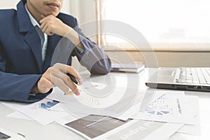 Business man calculate about cost and doing finance at office, Finance managers task,Concept business and finance investment photo