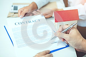 Business man calculated cost and sign agreement contract, Insurance Home concept photo