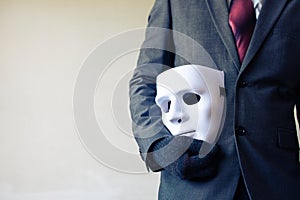 Business man carrying white mask to his body indicating Business fraud and faking business partnership