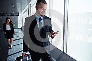 Business man, cellphone or travel by airport window for reading, thinking or contact in corridor with smile