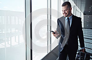 Business man, cellphone and window in airport hallway for reading, thinking or vision on international travel