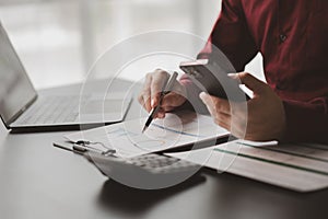 Business man checking financial documents, he owns a startup company.