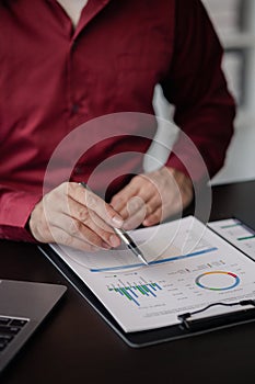 Business man checking financial documents, he owns a startup company.