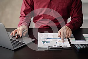 Business man checking financial documents, he owns a startup company.