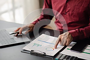 Business man checking financial documents, he owns a startup company.