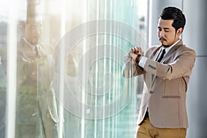 Business man checking time on smart watch in office