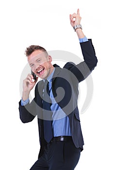 Business man cheers while on phone