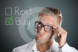 Business Man Choosing Rent Or Buy Option