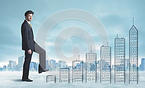 Business man climbing up on hand drawn buildings in city