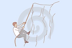 Business man climbs up cliff, taking on difficult challenge, does not stop trying to achieve goal