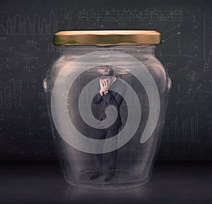 Business man closed into a glass jar concept