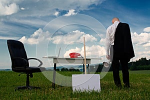 Business man at desk outside