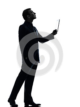 Business man digital tablet looking up silhouette