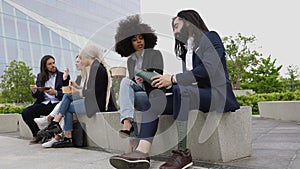 Business man with disability adjusting his prosthetic leg while teamwork having lunch break outside office