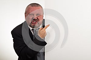 Business man displaying a banner add isolated over a white background