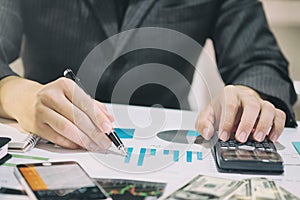 Business man doing finances on calculate analysis working with f