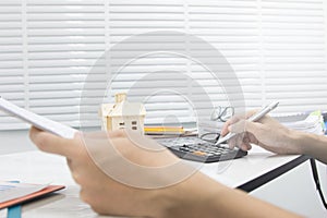 Business man  doing finances and calculate on desk about cost at work office.payment concept