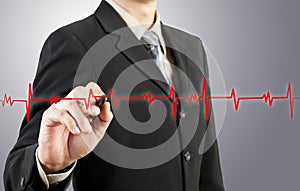 Business man drawing chart heartbeat